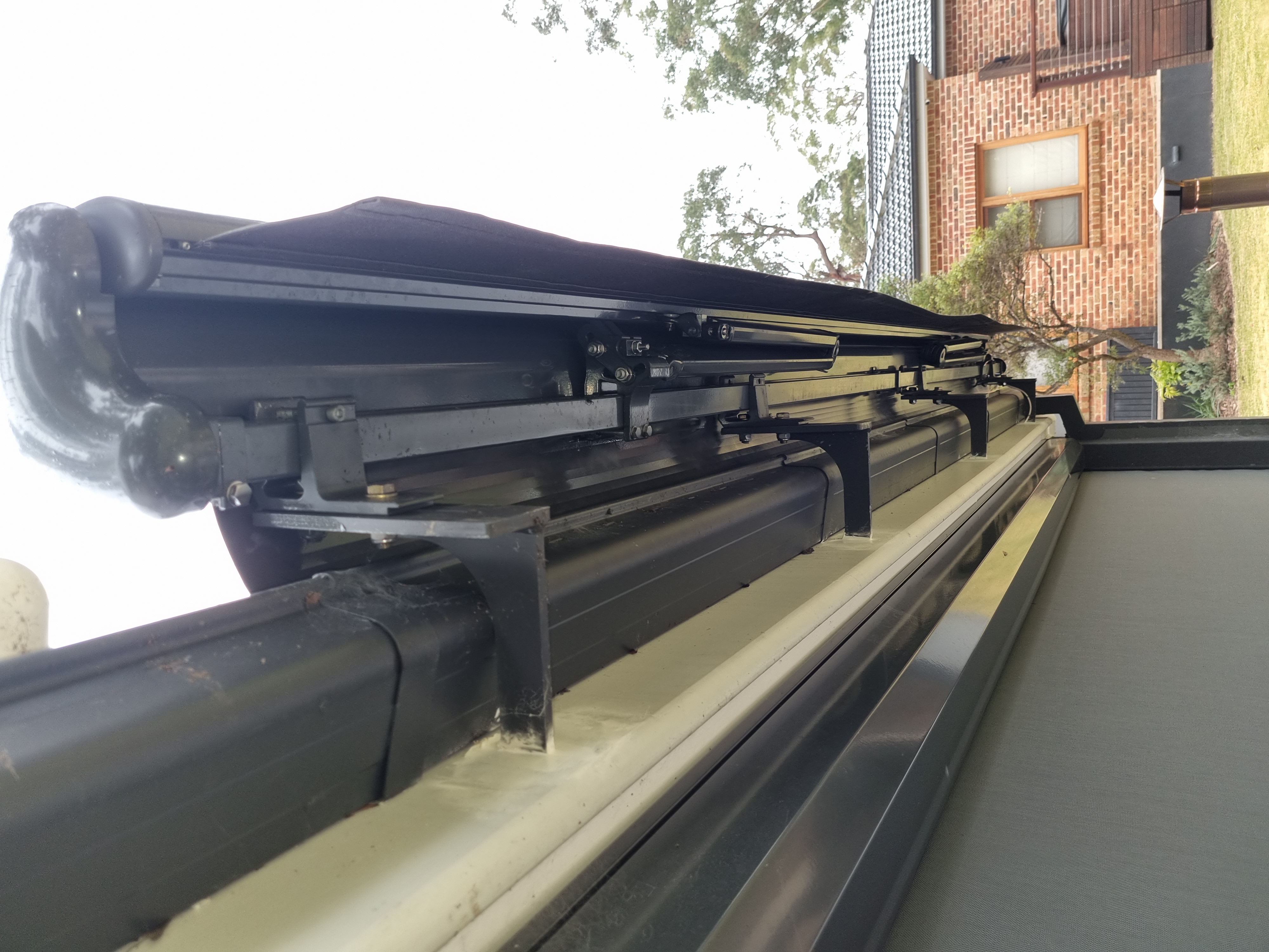 Folding arm awning bracket and arm mechanism under inspection — Shutters of Sydney