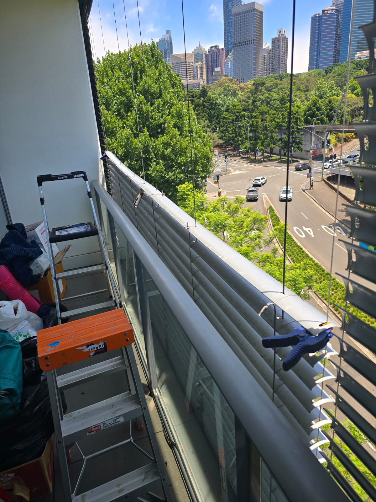 External venetian blind service access on a Sydney CBD high-rise balcony — Shutters of Sydney