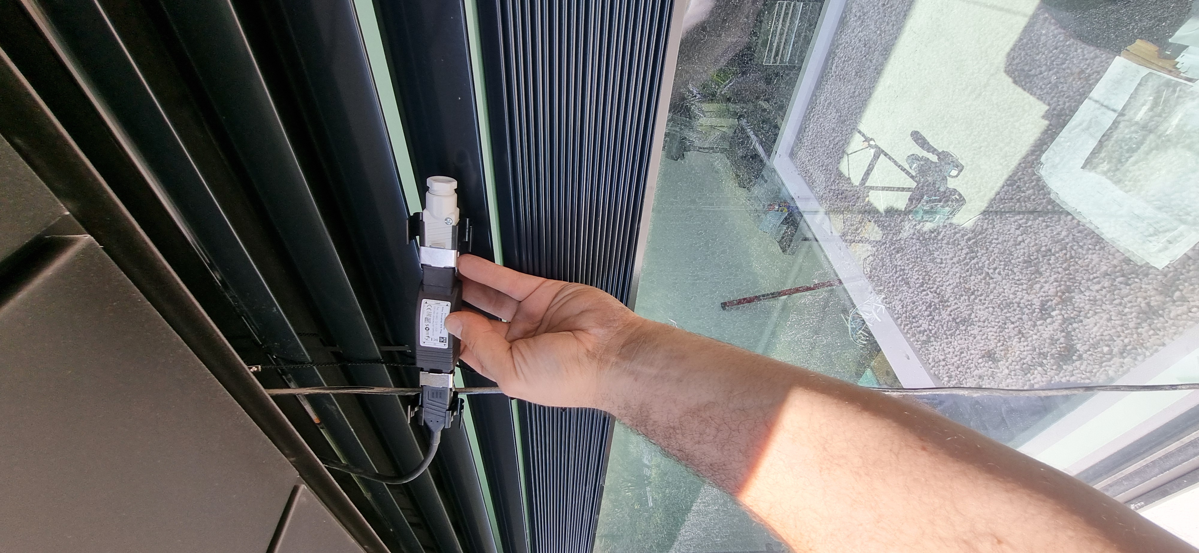 External venetian blind motor and connector being inspected during diagnostics — Shutters of Sydney